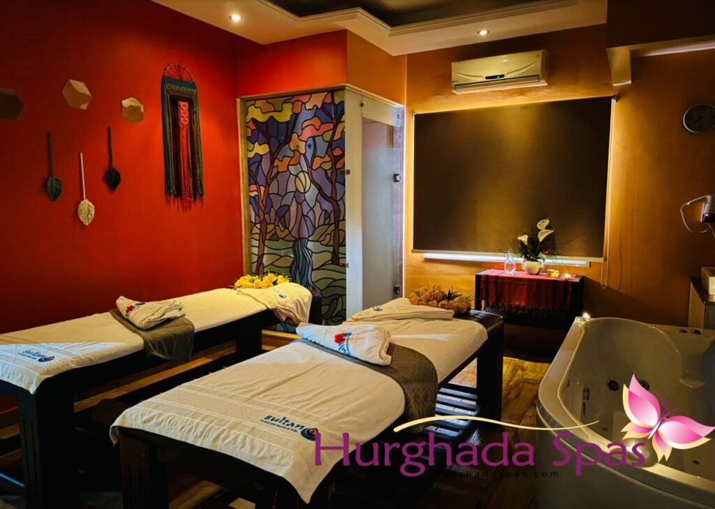 Professional Aromatherapy Massage setup at Sultan Spa featuring luxury treatment beds and a private relaxation jacuzzi.