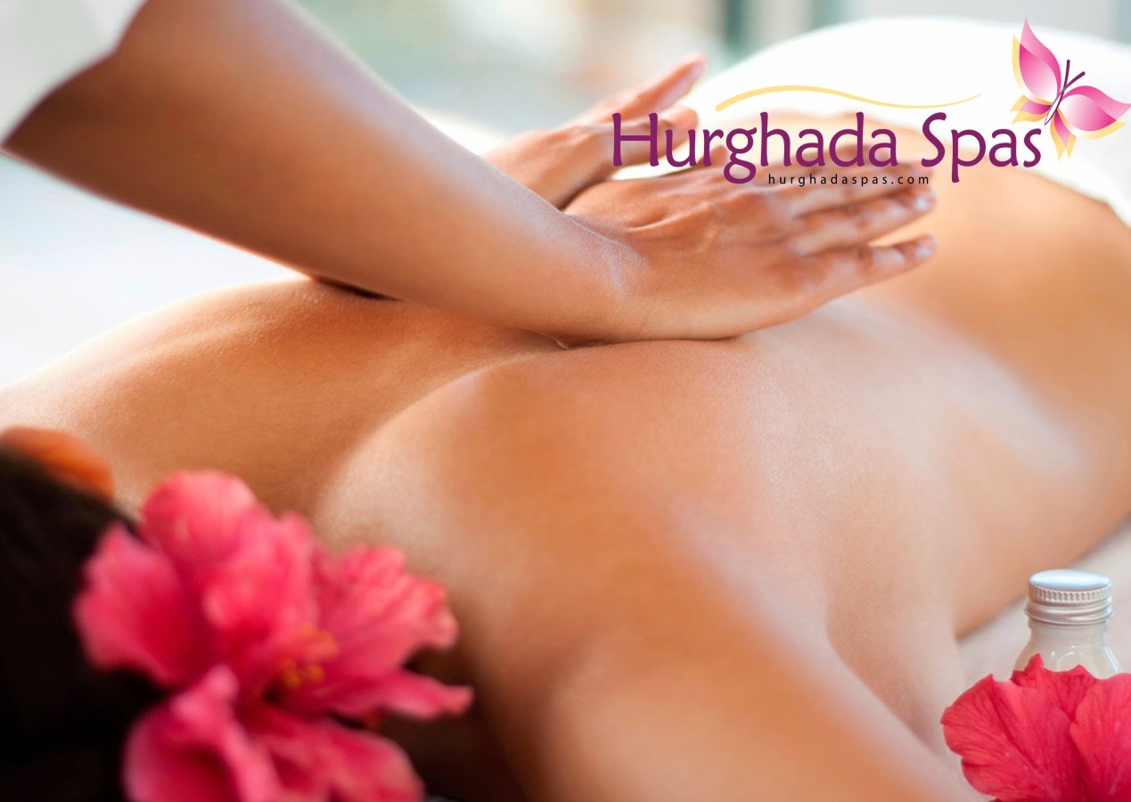 Professional therapist performing a specialized Anti-Cellulite Massage at Egyptos Spa using natural oils and tropical flowers for relaxation.