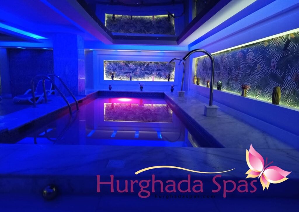 Indoor luxury swimming pool lit with blue neon lights at the best spa in makadi bay offering relaxation and massage treatments.