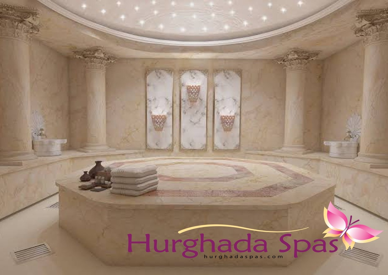 A luxurious marble interior with grand columns and a central octagonal platform for The Complete Guide to the Turkish Hamam Experience.